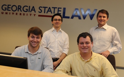 Moot Court team members: Front Row (L to R): Brian Klein, 2L; Chad Brock, 2L. Back Row (L to R): Charles Carmichael, 2L; Coach Raymond Lindholm, 3L.
